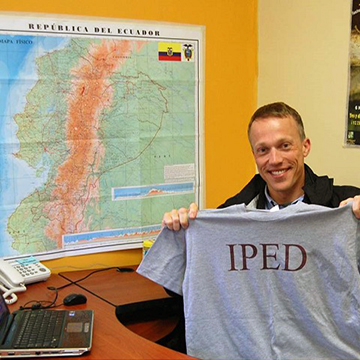 IPED student holding an IPED t-shirt