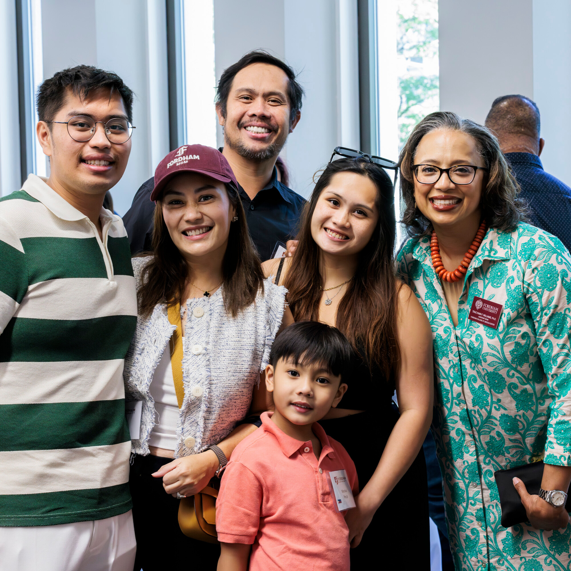 Family posing with Dean at welcome reception inside of Lowenstein Center