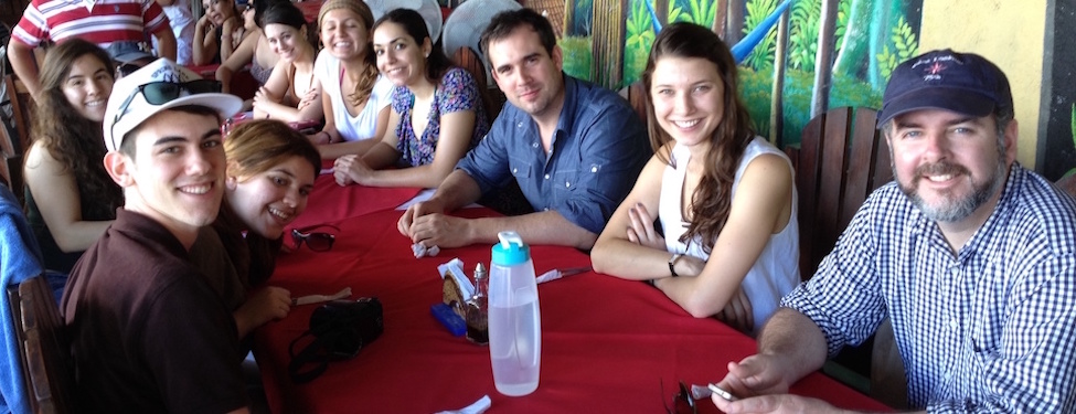 Group of students sitting around a lunch table in Nicaragua during an Institute of International Humanitarian Affairs January break trip