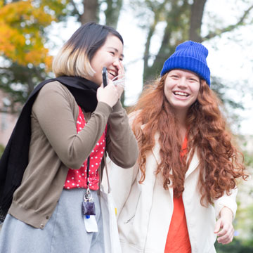 Two Female Students Laughing Together