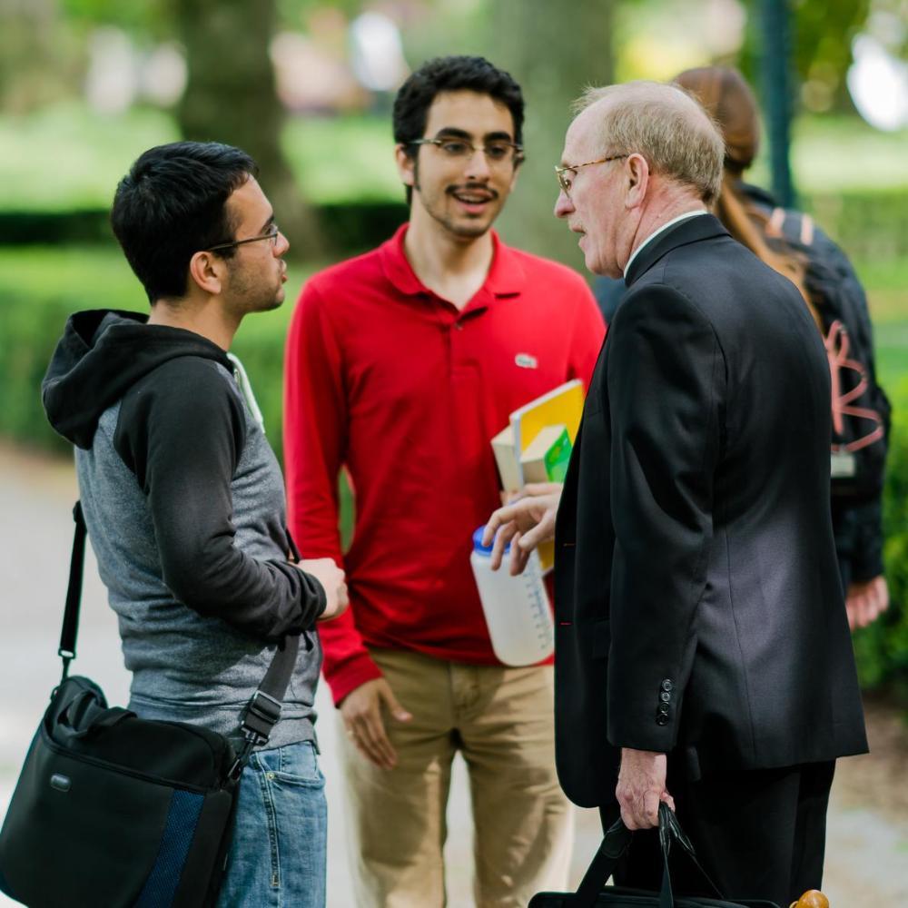 Father McShane Chats with Students on the Rose Hill Campus