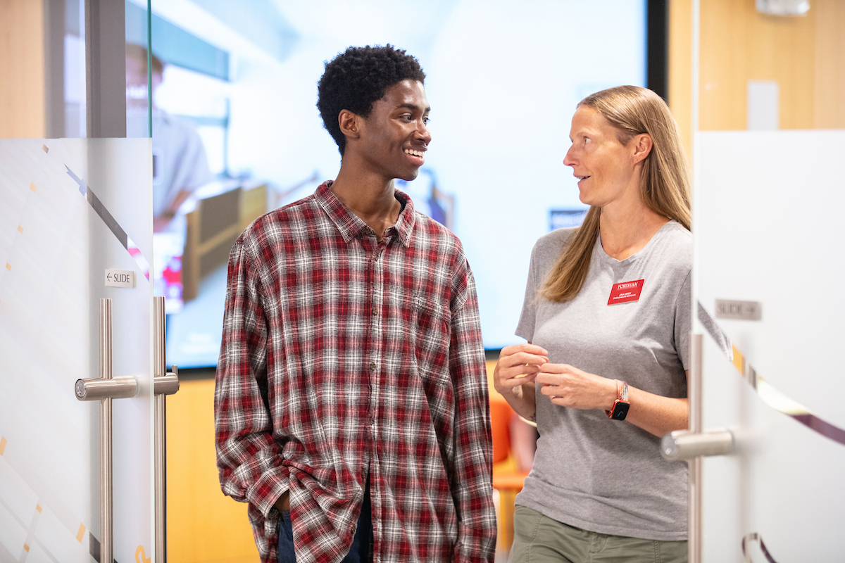Two students talking in a classroom at LC