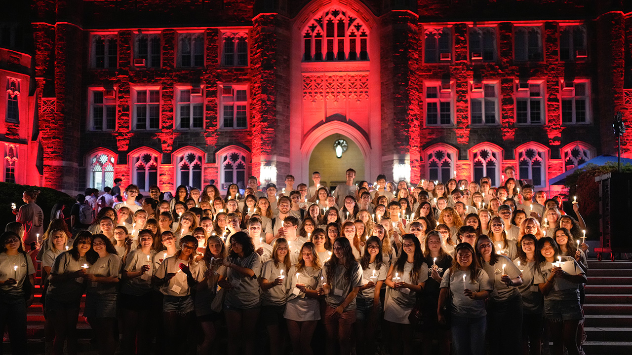 Fordham students hold candles during the traditional ceremony on Edwards Parade
