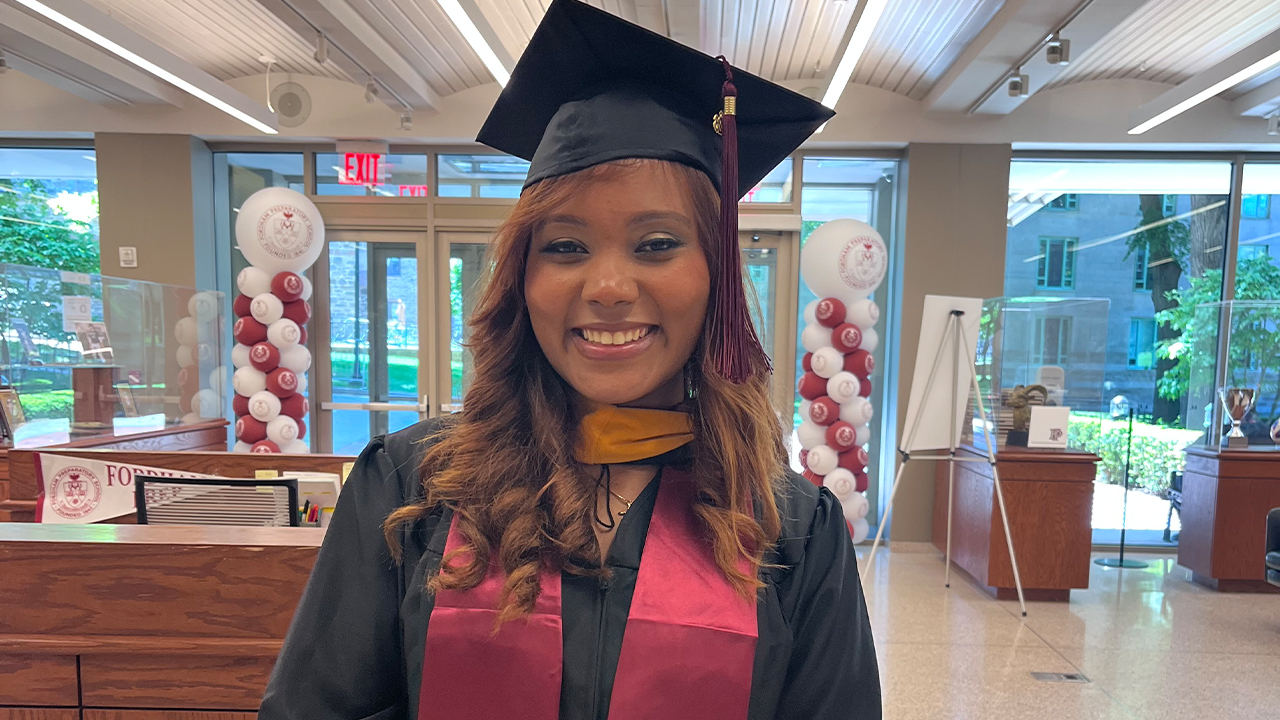 Stephanie De La Cruz standing inside Fordham Prep at Commencement at Rose Hill