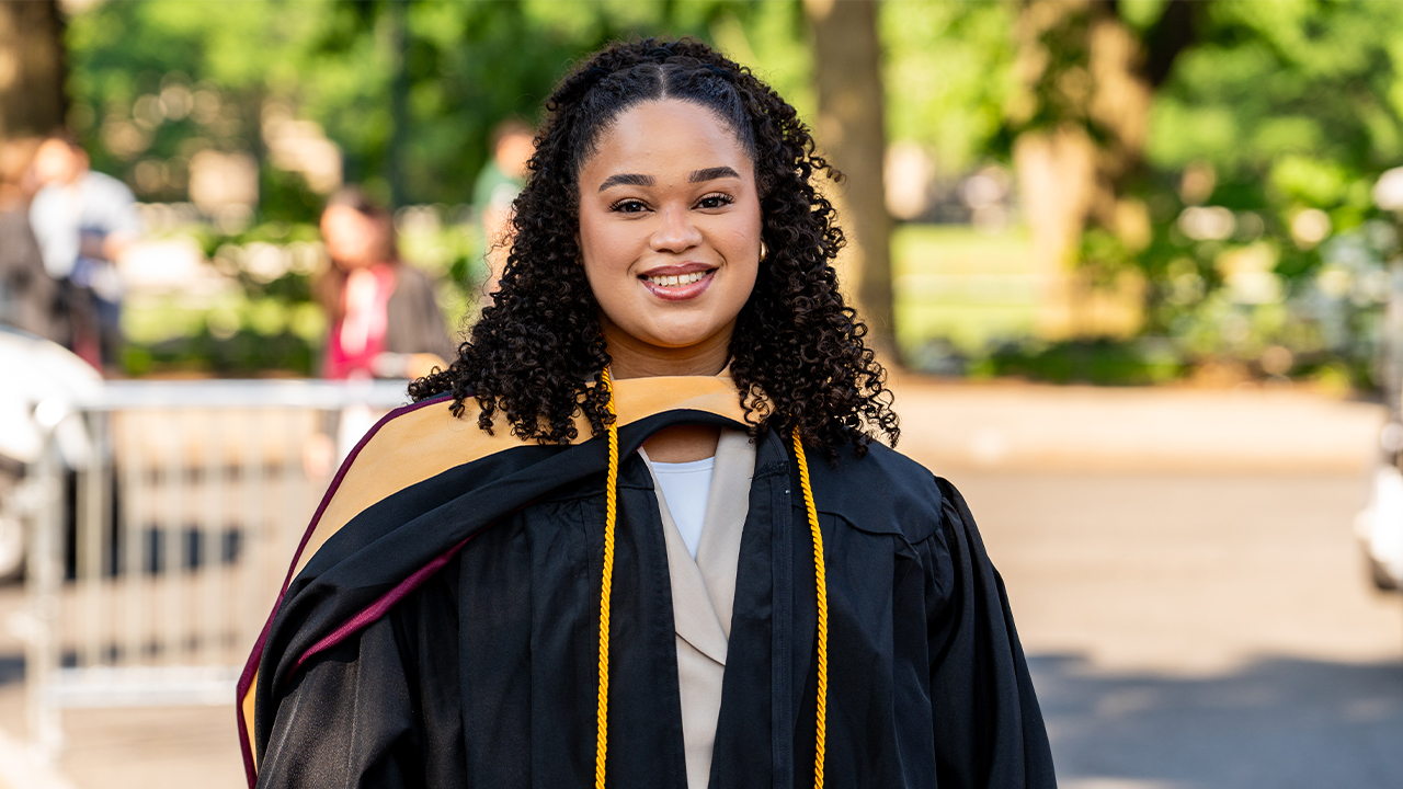 MSW grad Nathaly Fernandez posing at her diploma ceremony at Rose Hill