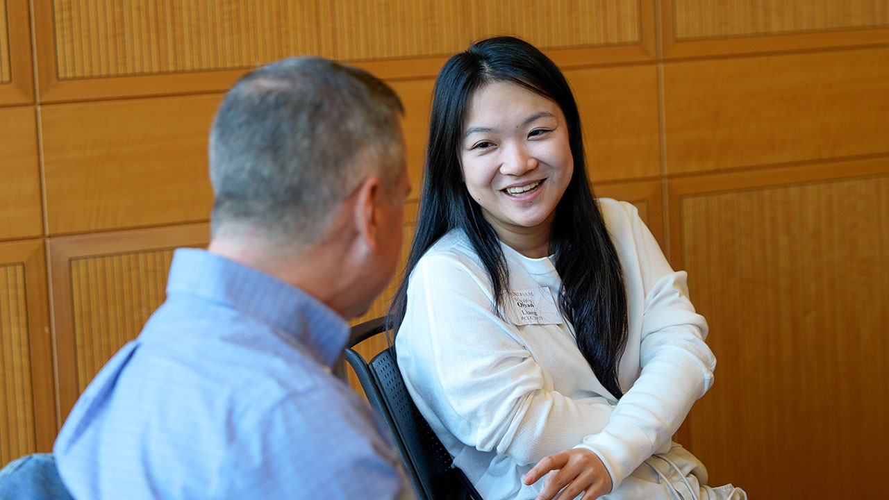 mentor and student chatting indoors