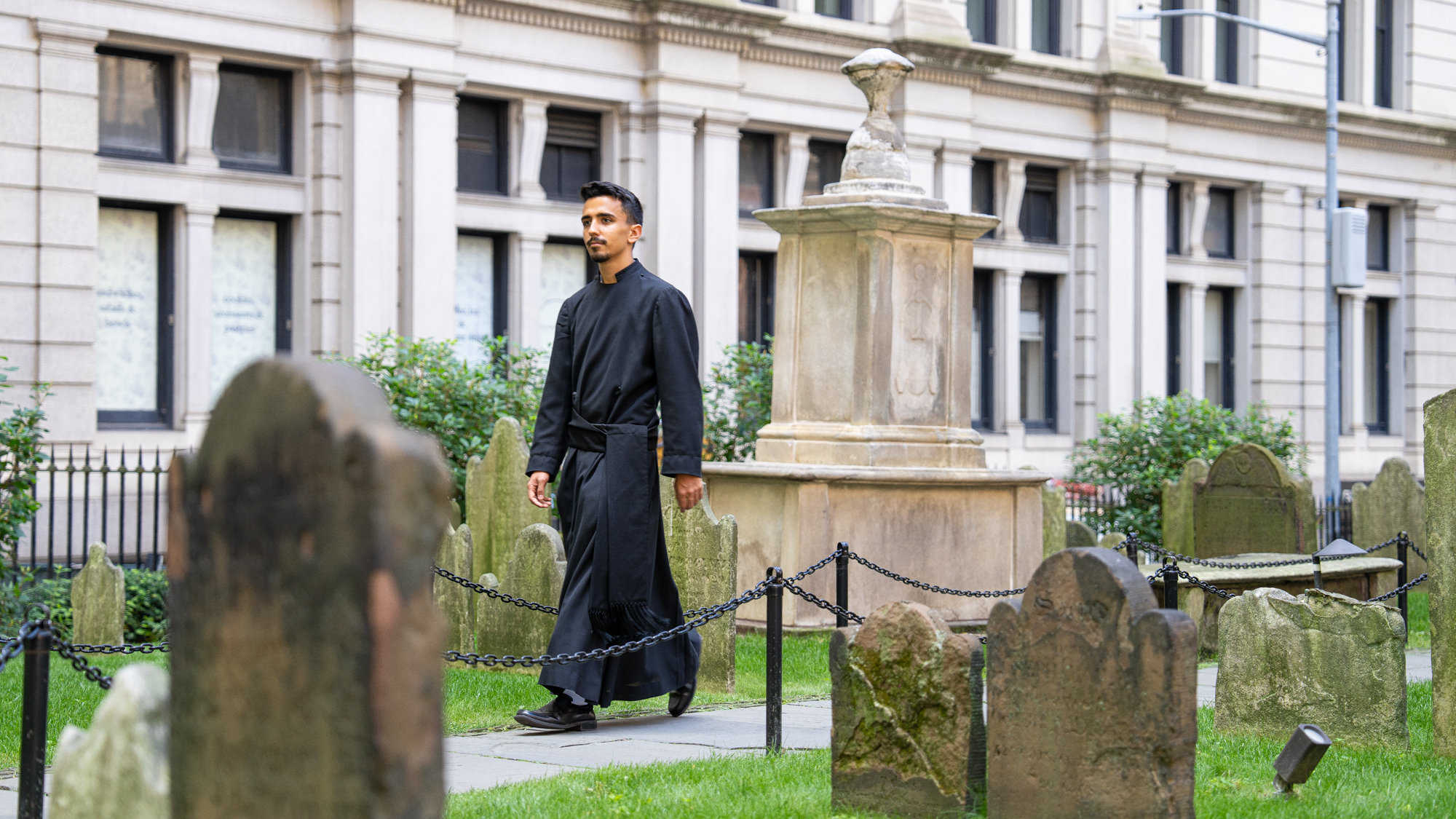 John Garza walks through Trinity Church burial ground