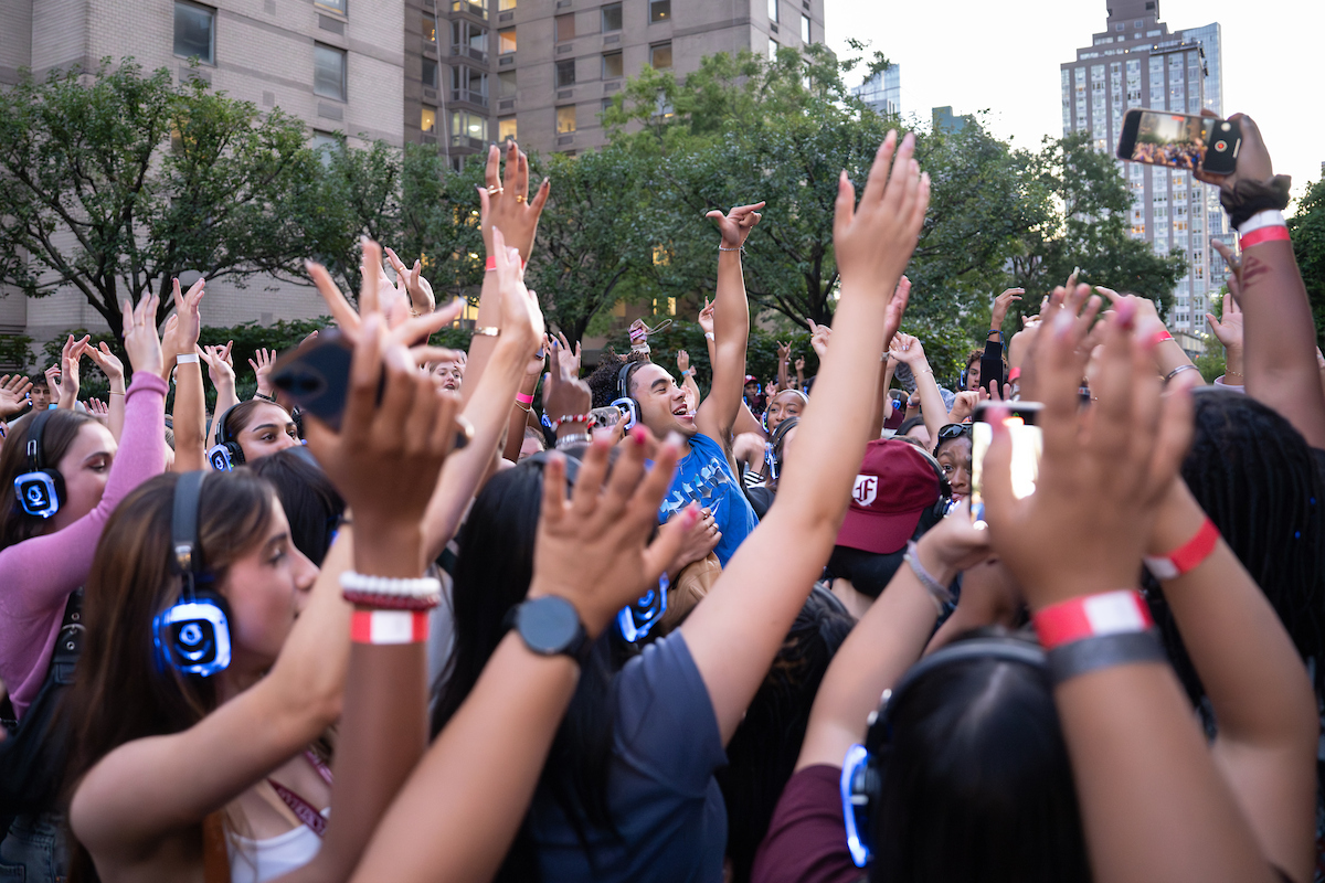 Students dance during silent disco at Fordham Lincoln Center plaza