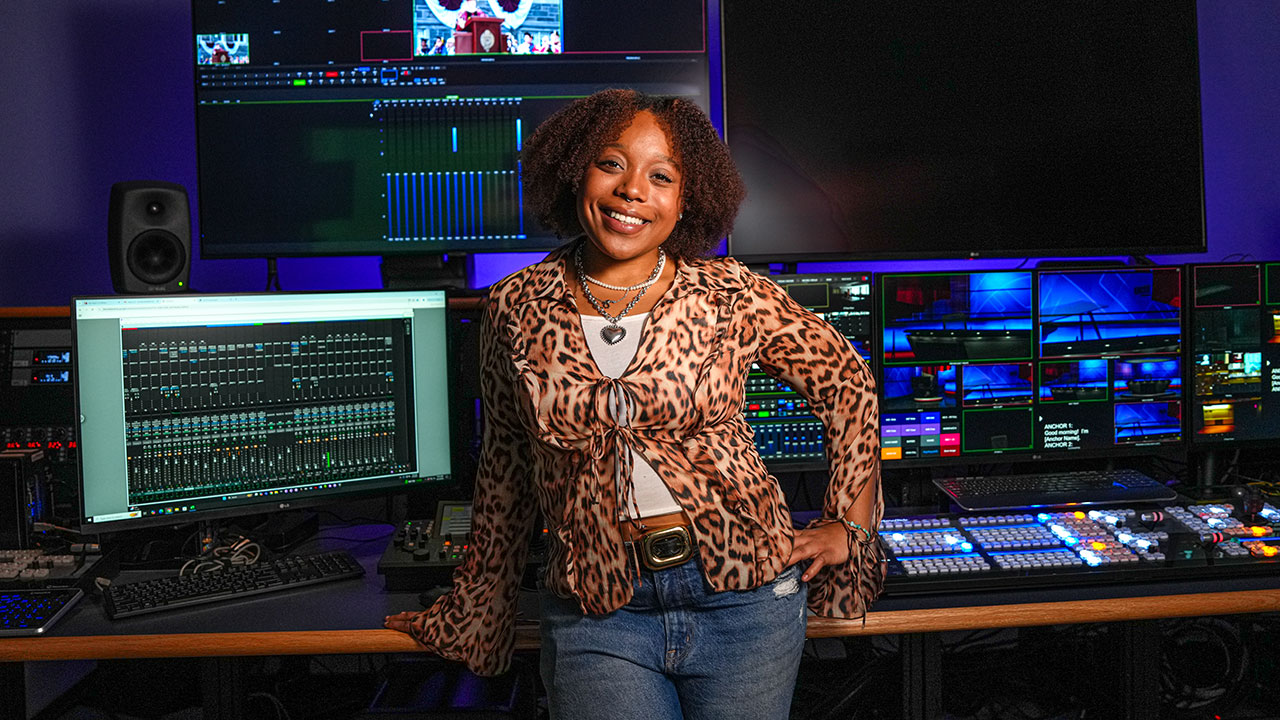 young woman posing for photo in tv studio