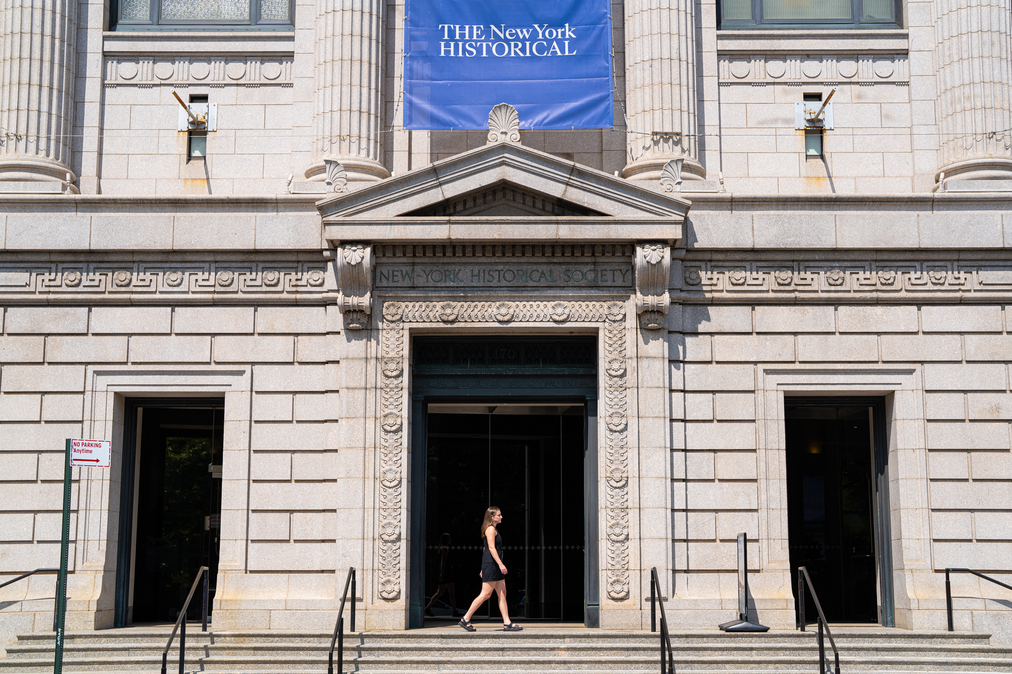 Fordham student Seneca Farhy walks in front of the entrance to The New York Historical during her Serving the City internship