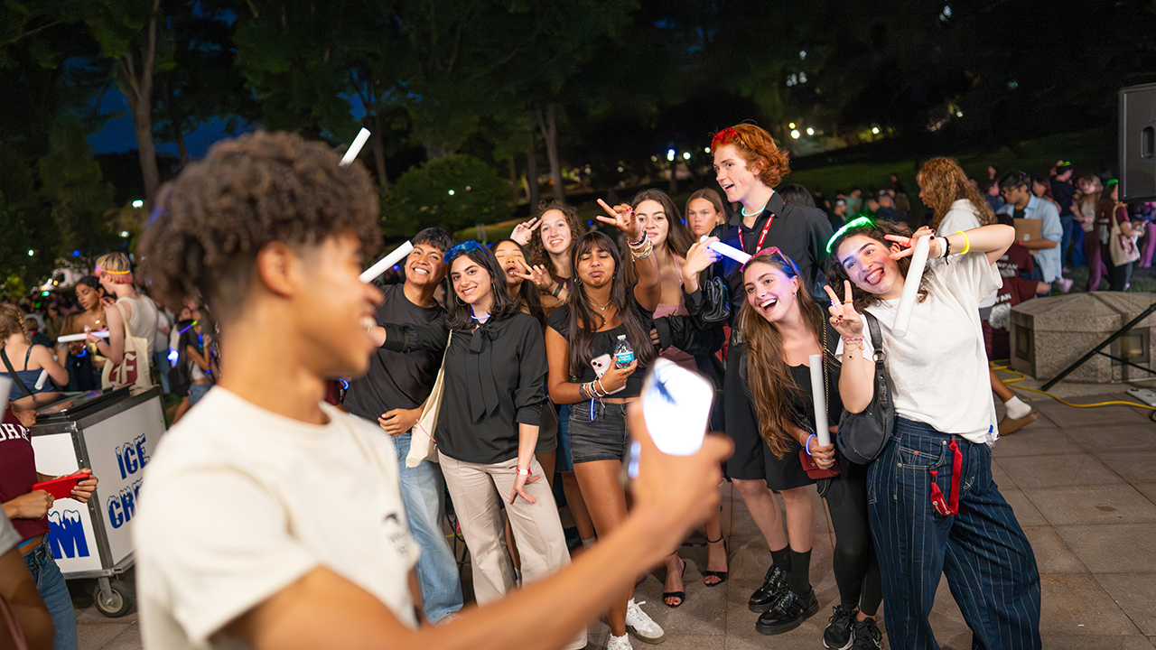 Fordham students pose for photos on the plaza during the opening week party