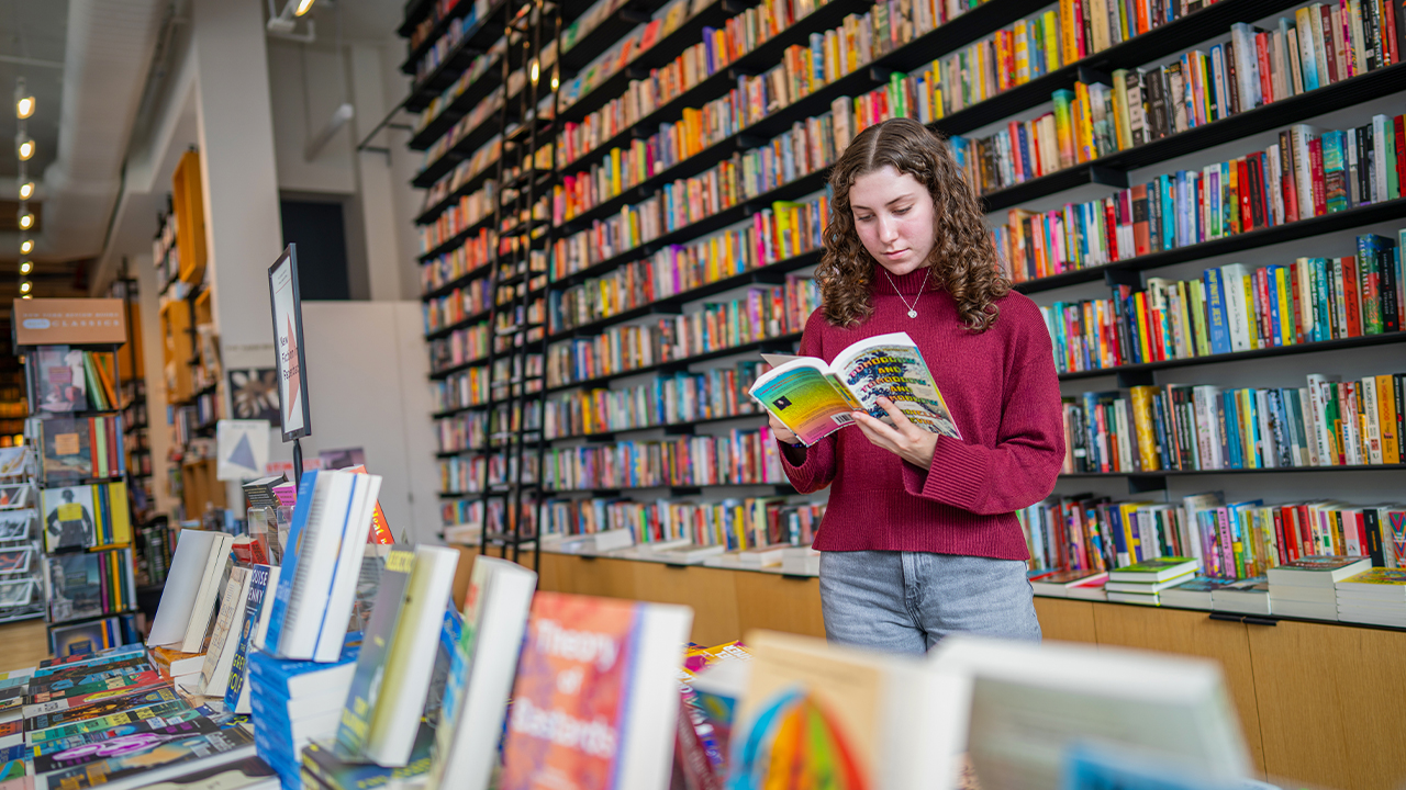 Madison Cossaboom reading in the bookstore at the Center for Fiction