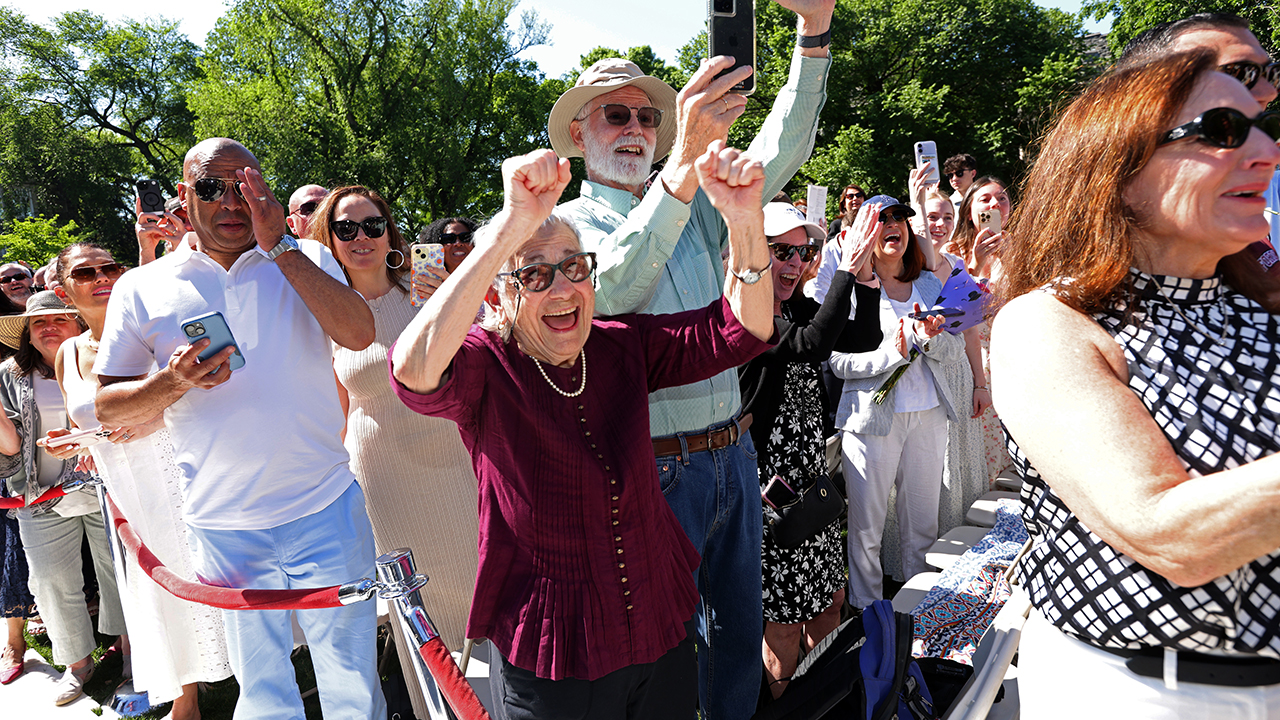 People cheer for their student