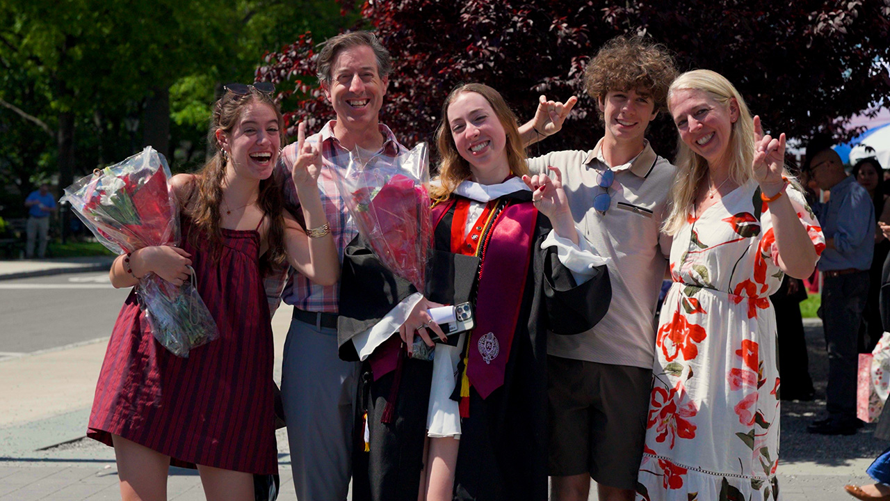 A family smiles at graduation