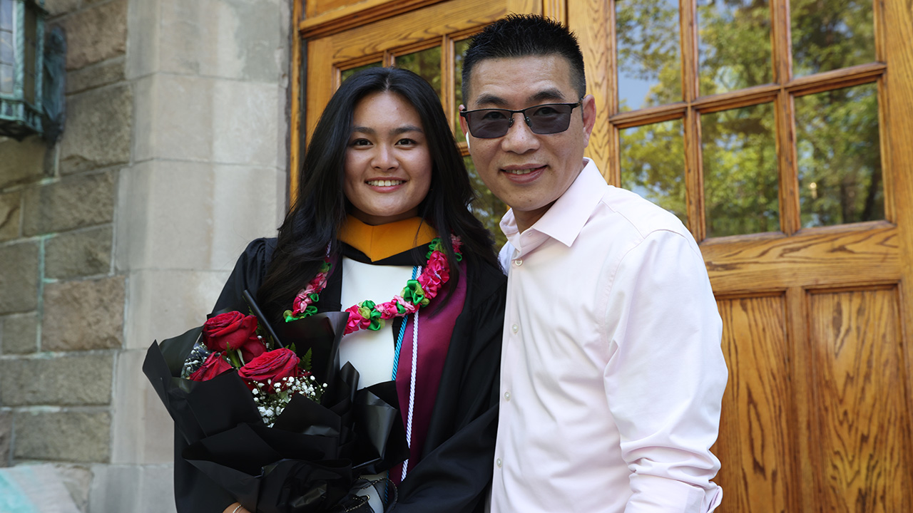 A father and daughter pose