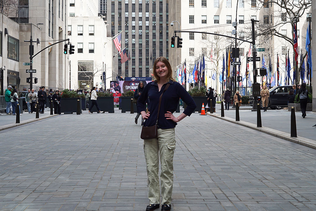 A student poses near Rockefeller Center