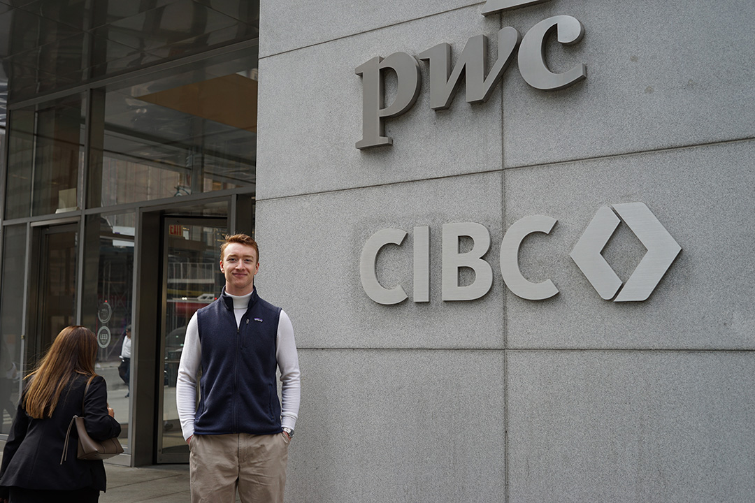 A student poses outside of PwC