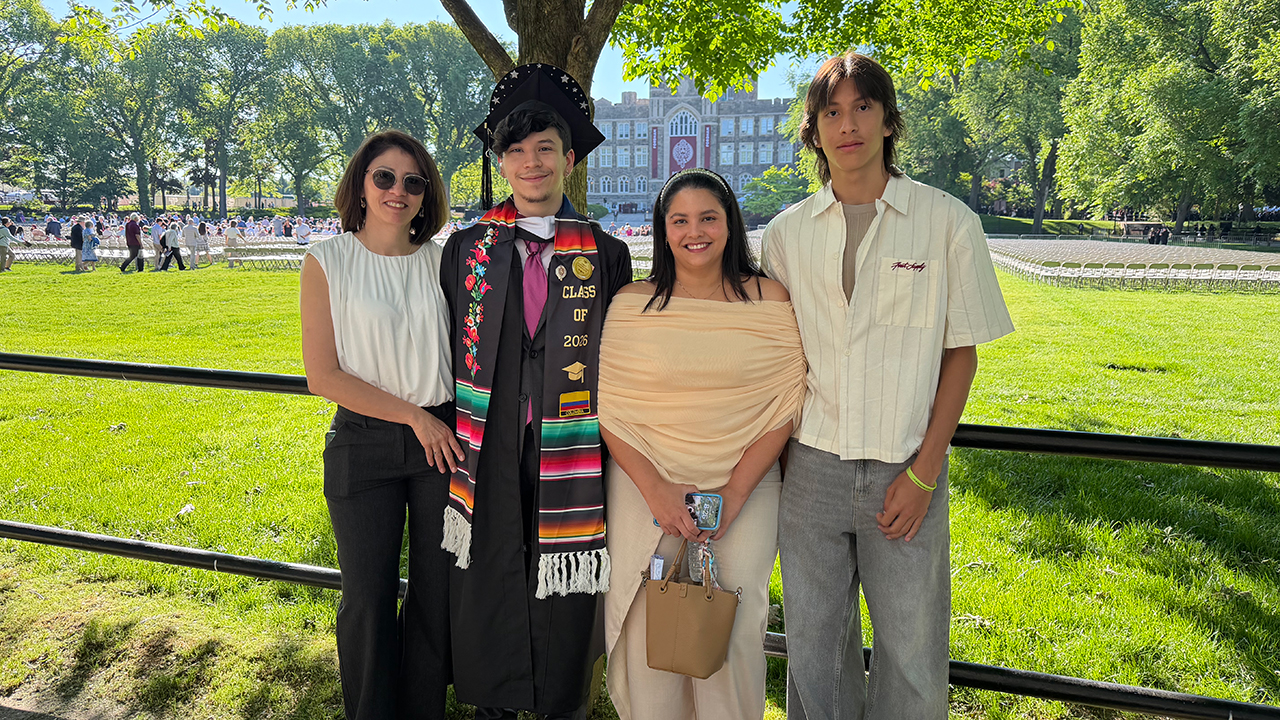 A family poses for a photo in front of Edwards Parade