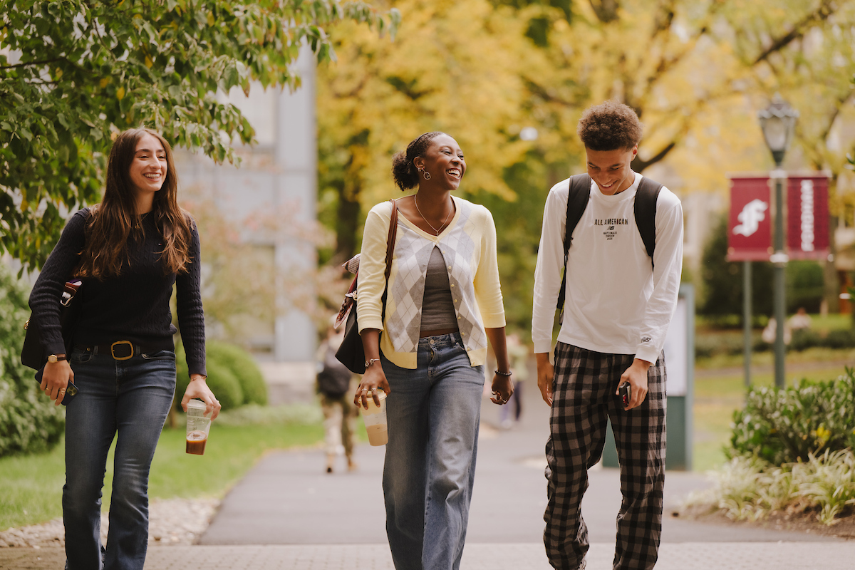 Students walk together on a pretty fall day on the Rose Hill campus