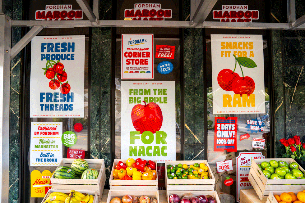Fruits and vegetables on display at the Fordham Maroon Mart with posters in the window