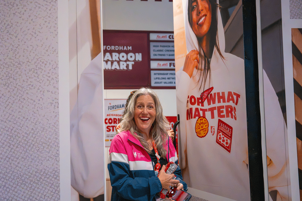 Visitor entering Fordham's speakeasy fashion boutique at NACAC through the secret door