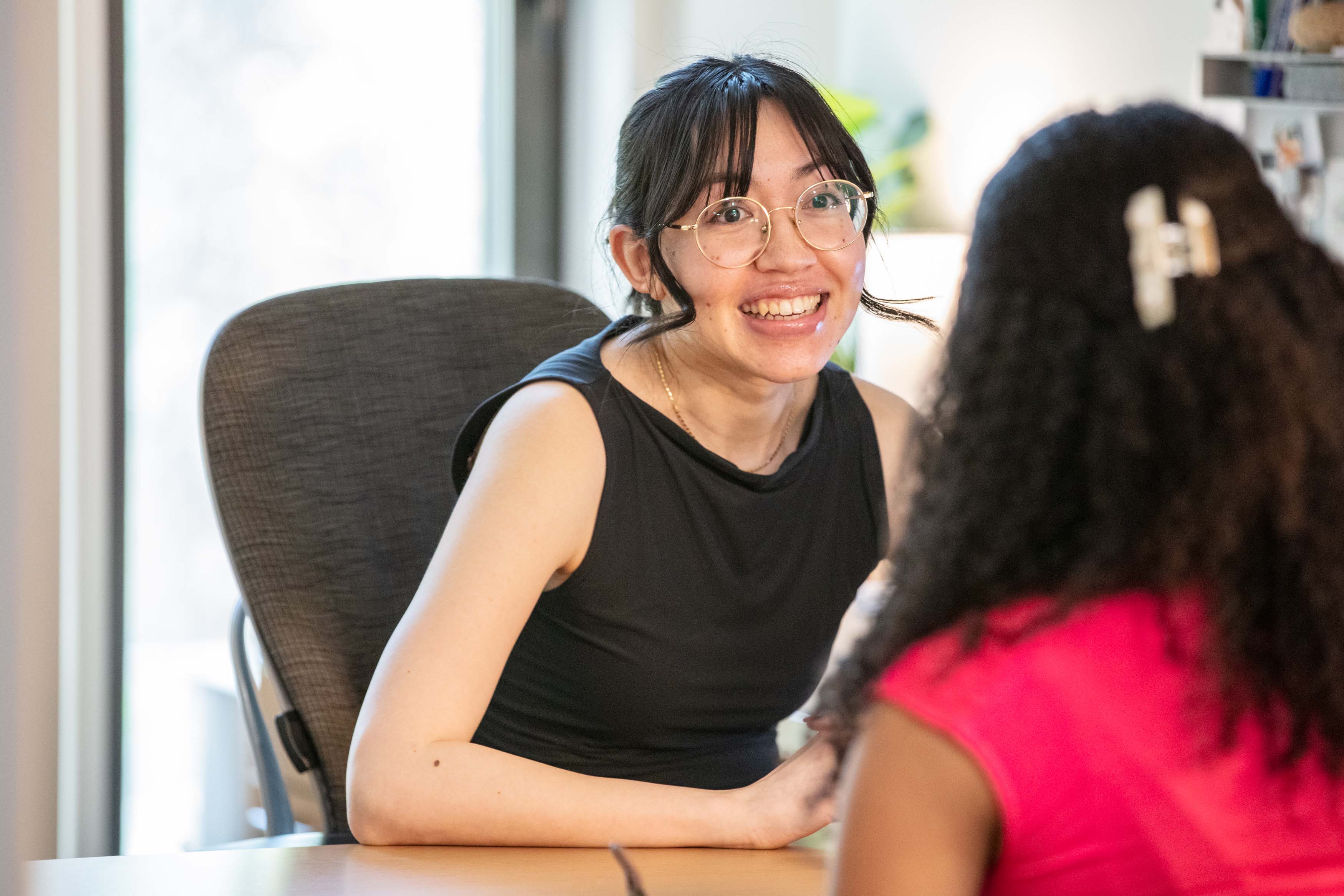 two females sitting talking in an office