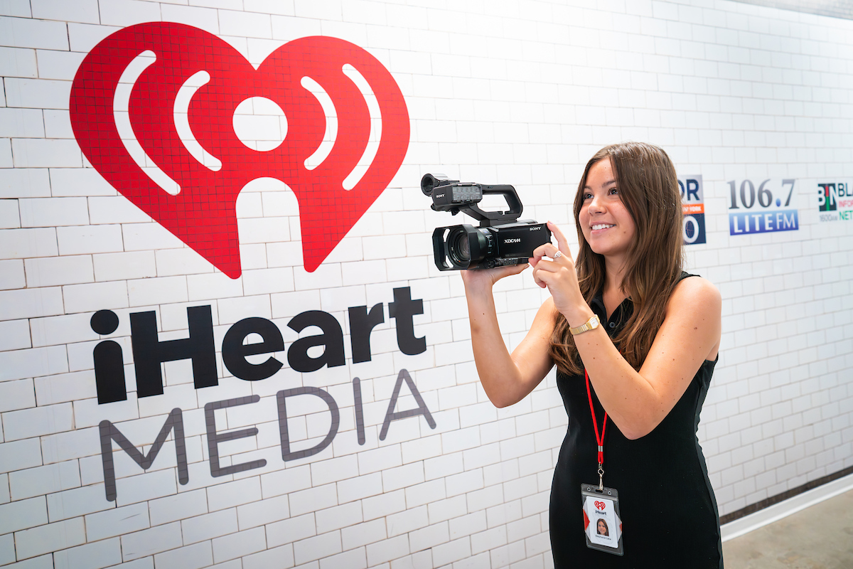 Stephanie Lane holding a camera at iHeartMedia studios