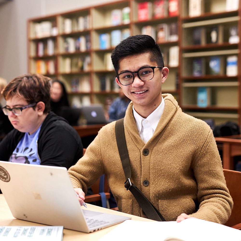 Student with laptop in library