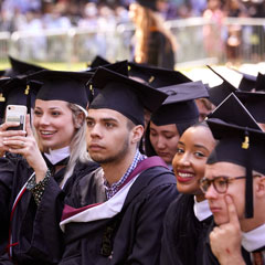 Graduating students watch the commencement ceremonies