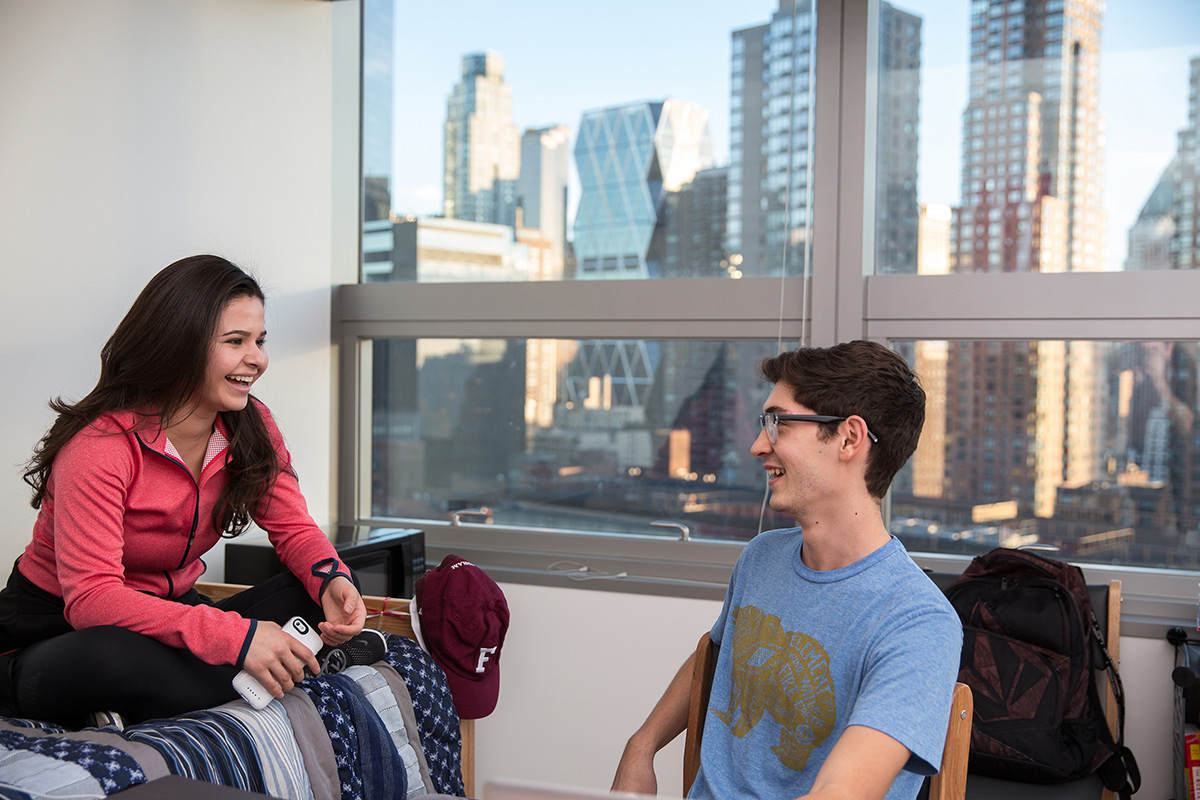 Two students having a conversation in a dorm room in McKeon Hall