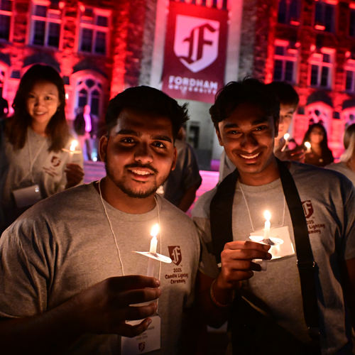 Two male students at the candle lighting ceremony as part of new student orientation
