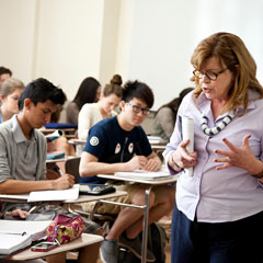 A female professor speaks in front of a class