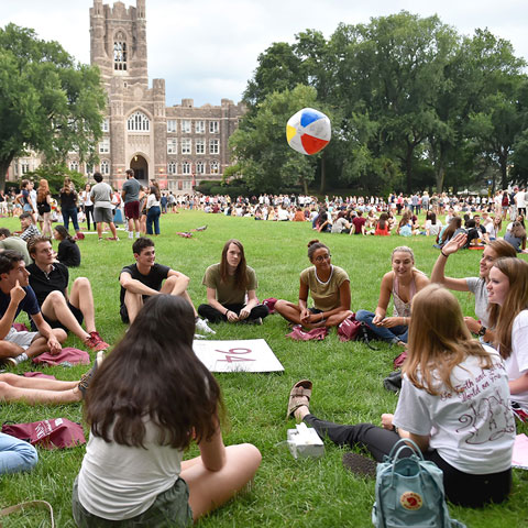 Students sit in groups on Eddie's Parade as part of New Student Orientation