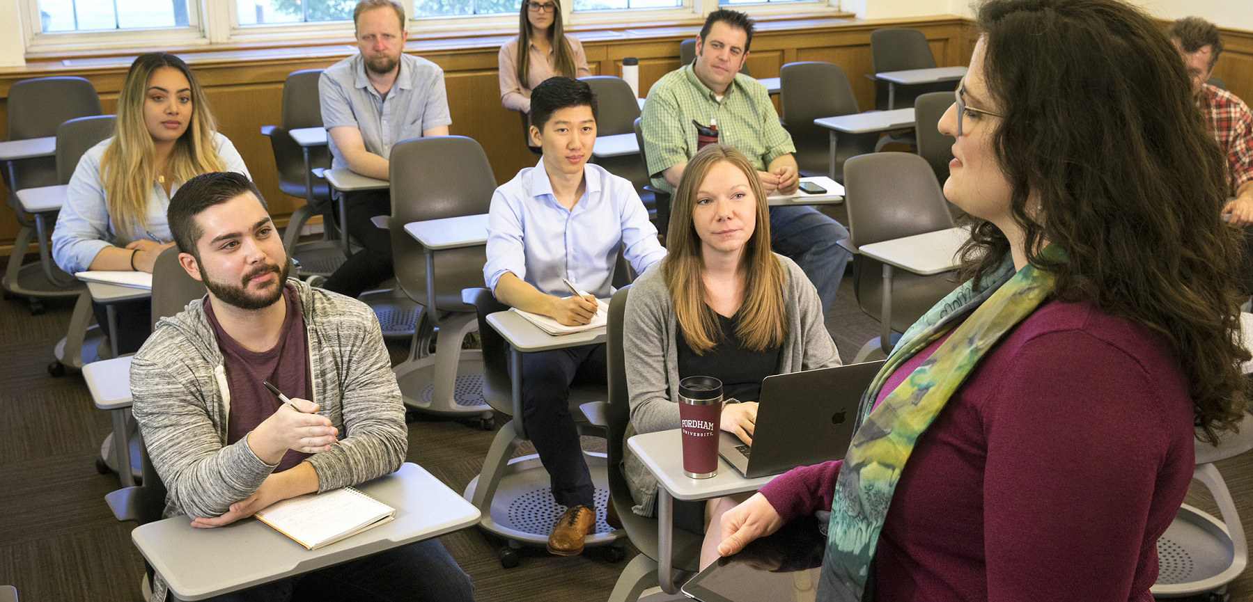 Students interacting with professor in classroom