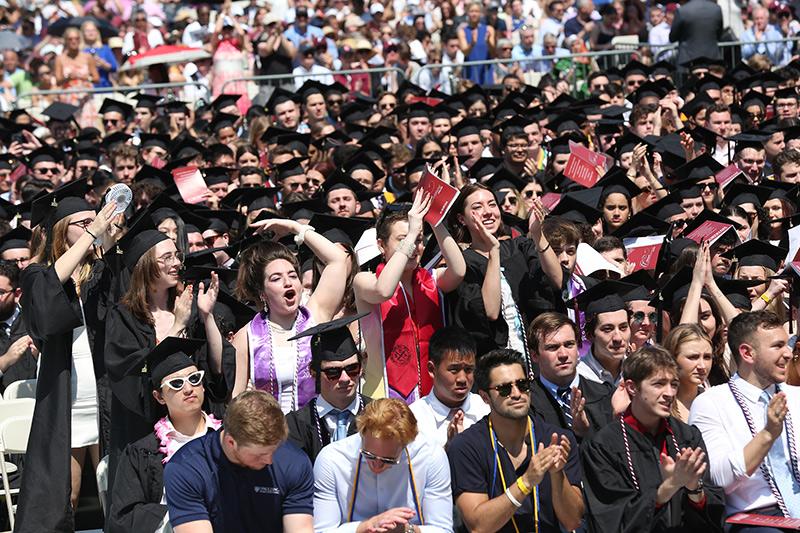Graduates cheering at Commencement 2022
