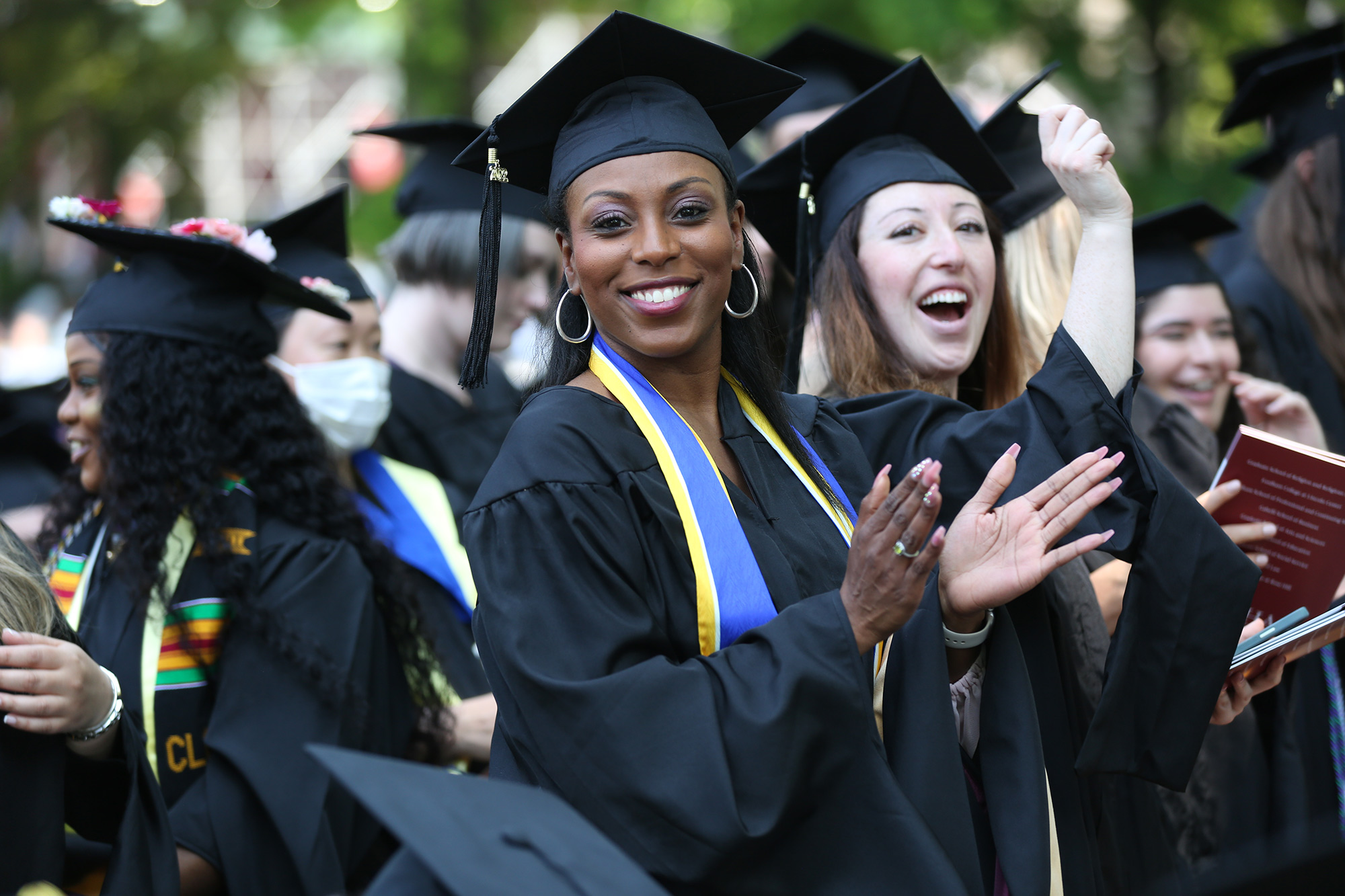 Female student clapping at Commencement 2022