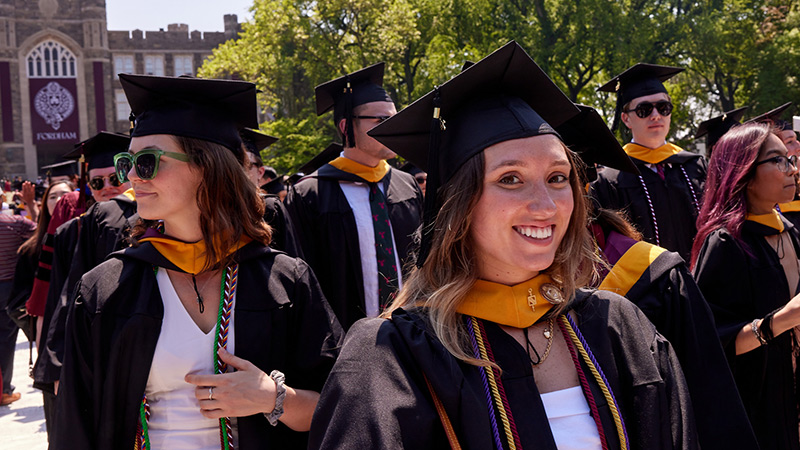 Female graduate walking away from stage, smiling