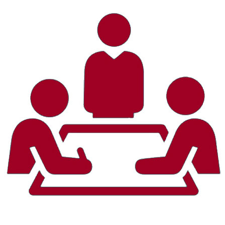 Silhouette of three people sitting at a desk