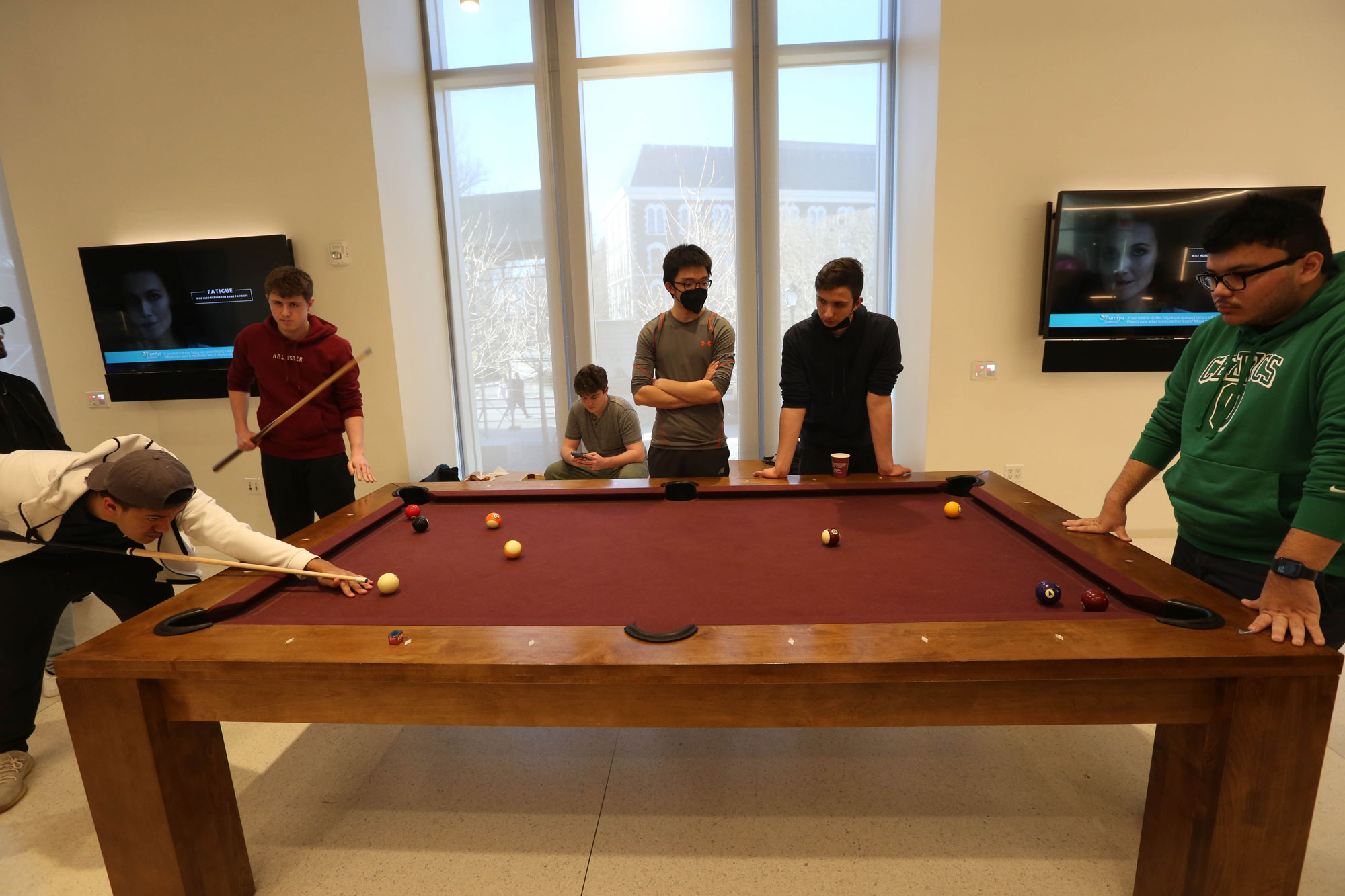 Students play pool in the McShane Center