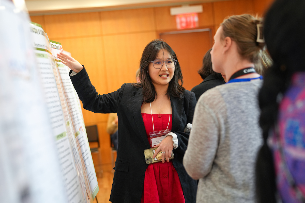 A GSAS student shares her poster at the GSAS Research Fair in Bepler Commons