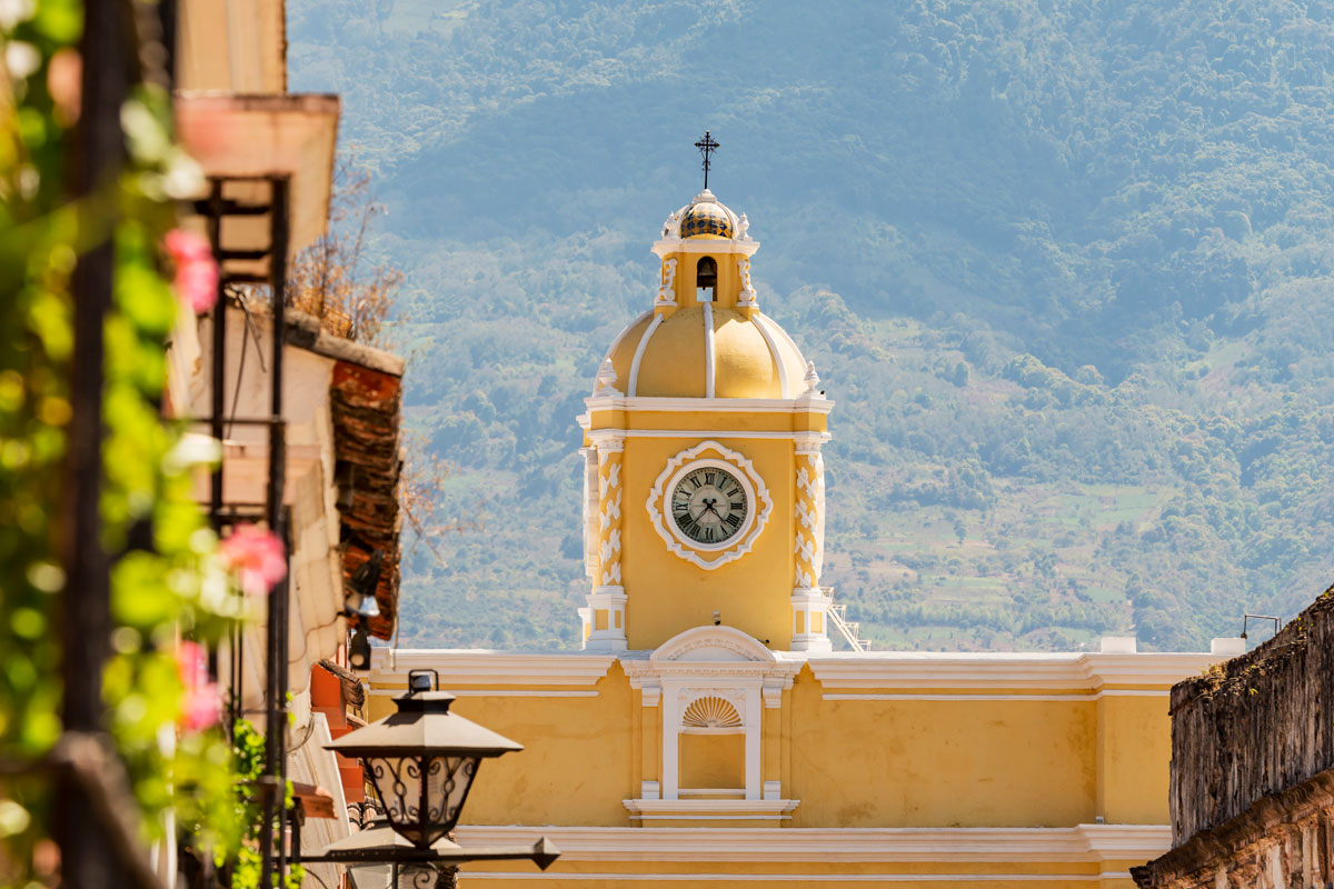 Antigua Guatemala, classic colonial town with famous Arco de Santa Catalina and Volcan de Agua behind