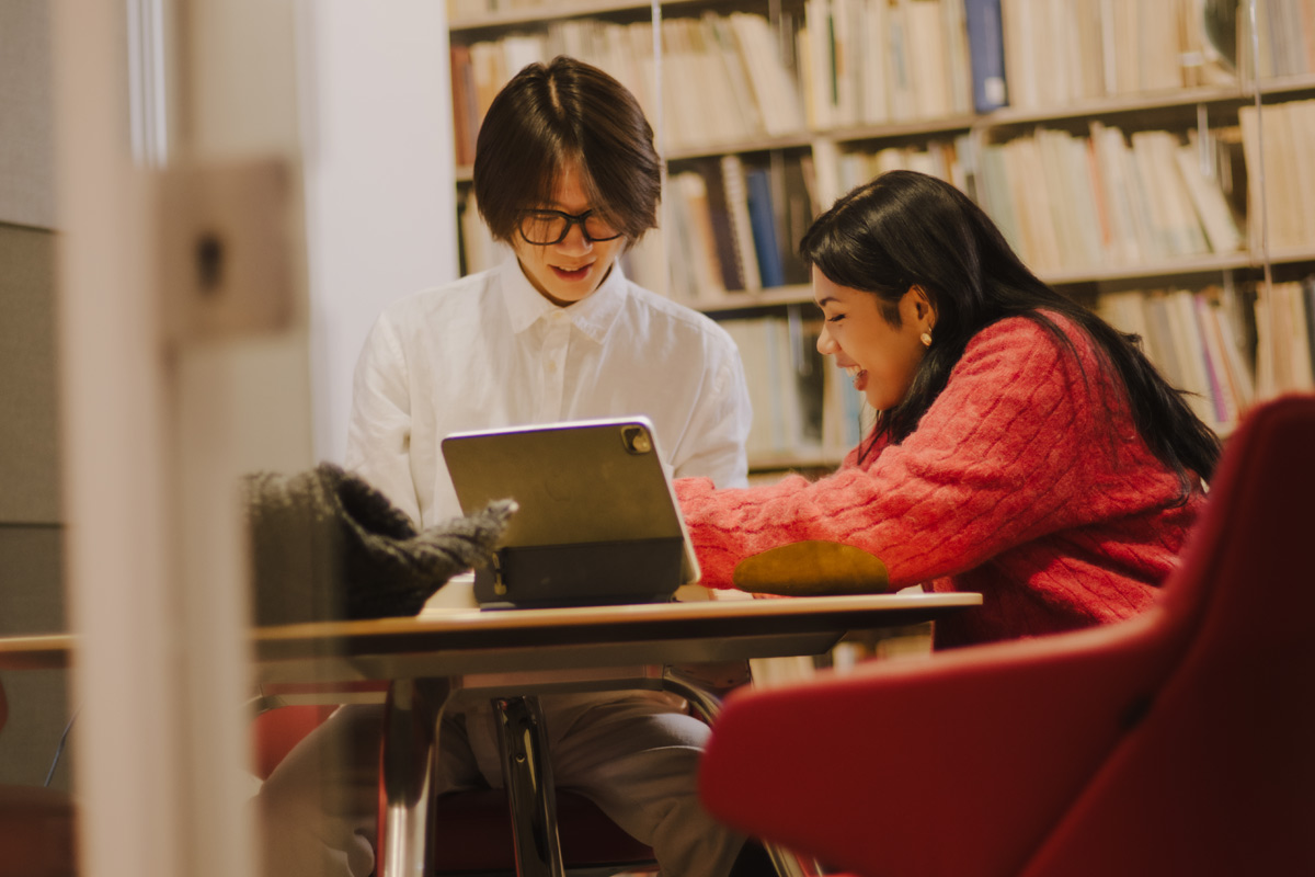 Two students studying together in the library
