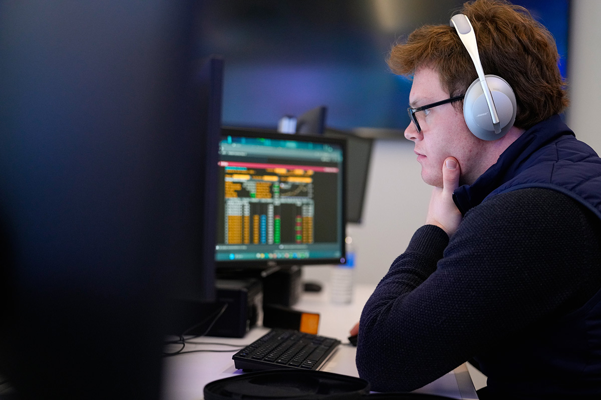 Side profile of a student working at their computer in a lab