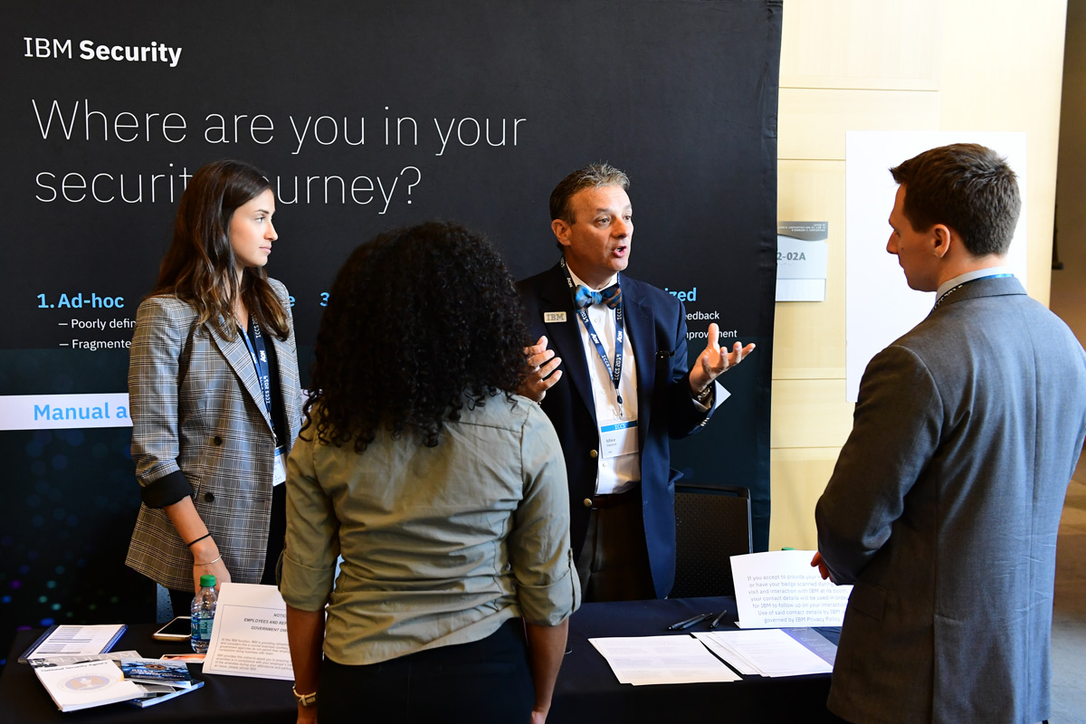 IBM security representatives talk with Fordham students at a job fair