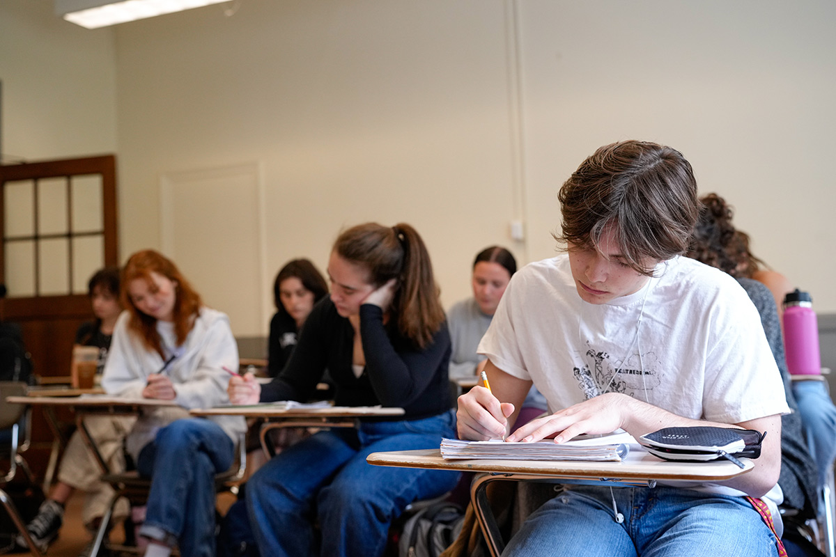 A group of students taking notes during a class lecture