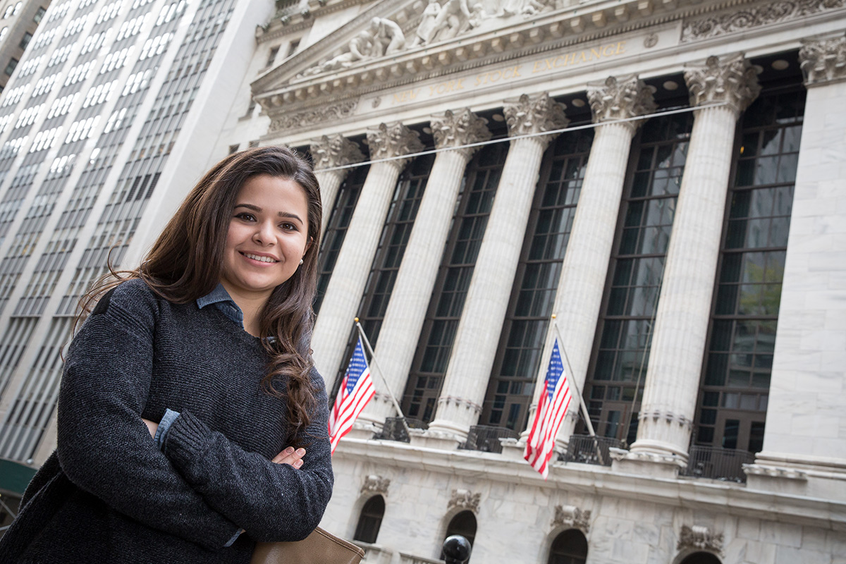 Female student standing in front of the NYSE