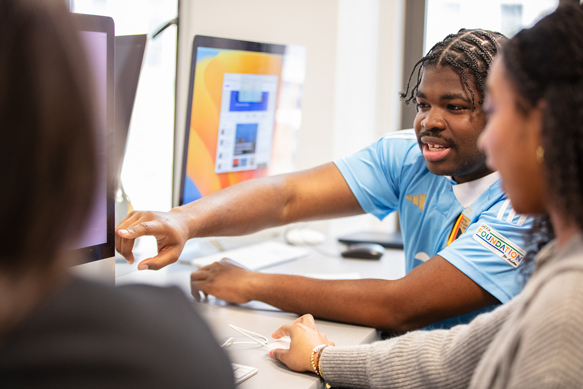 Students working together at a computer screen