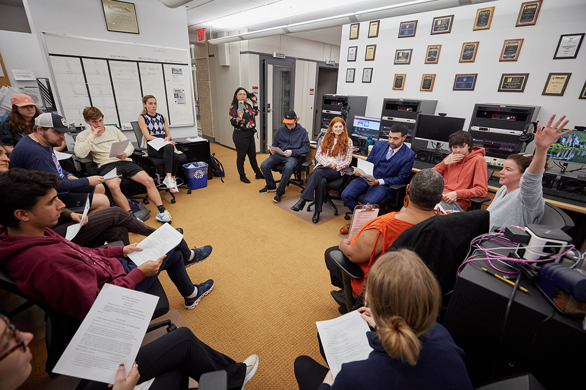 Sports journalism students in discussion in a classroom