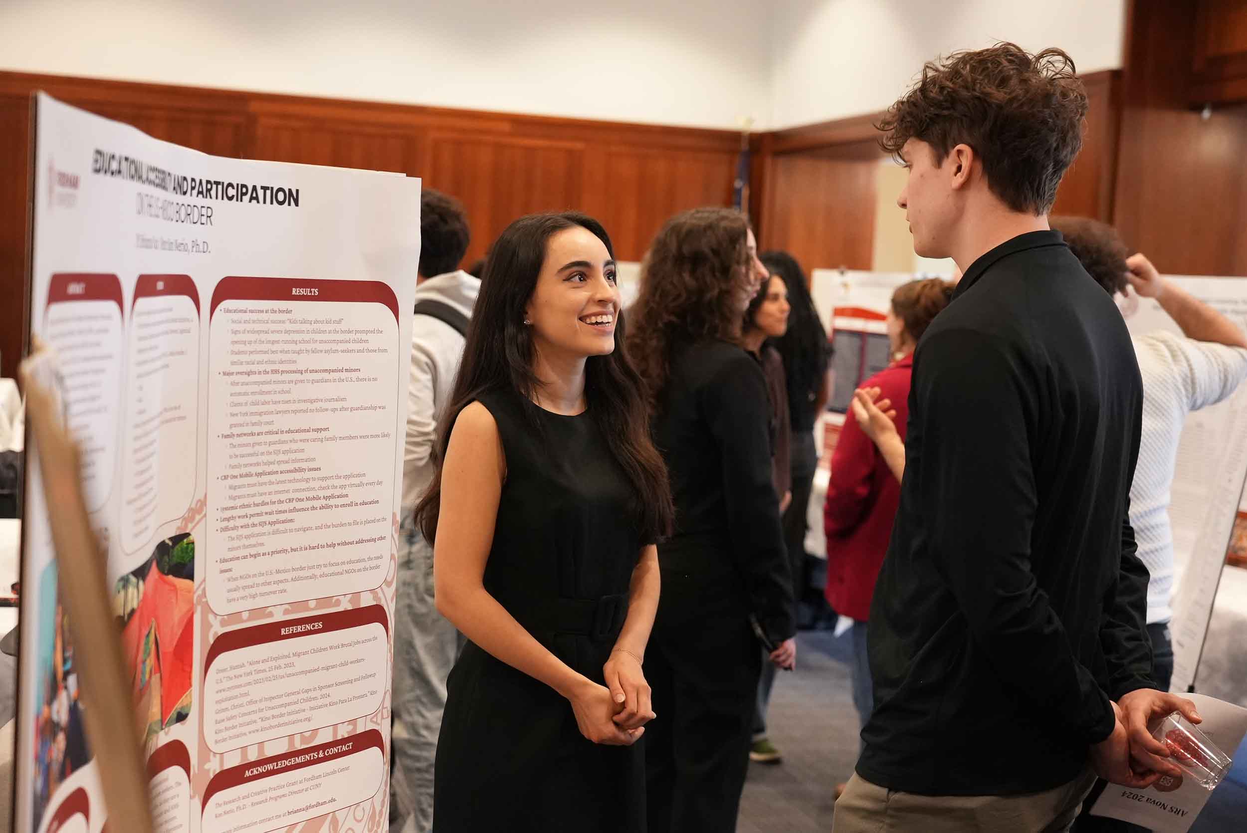 two students at research event