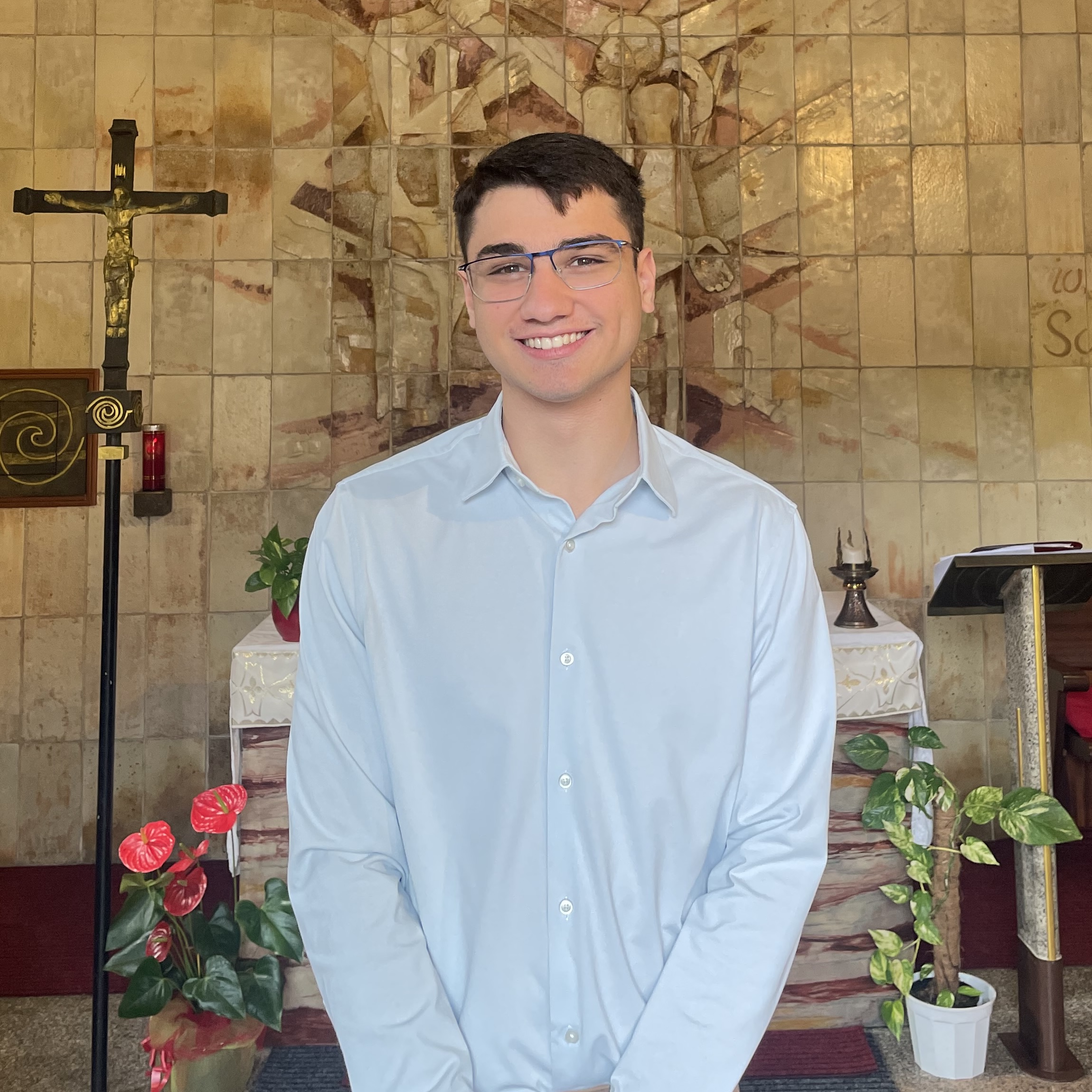 student in front of La Sorta Chapel smiling